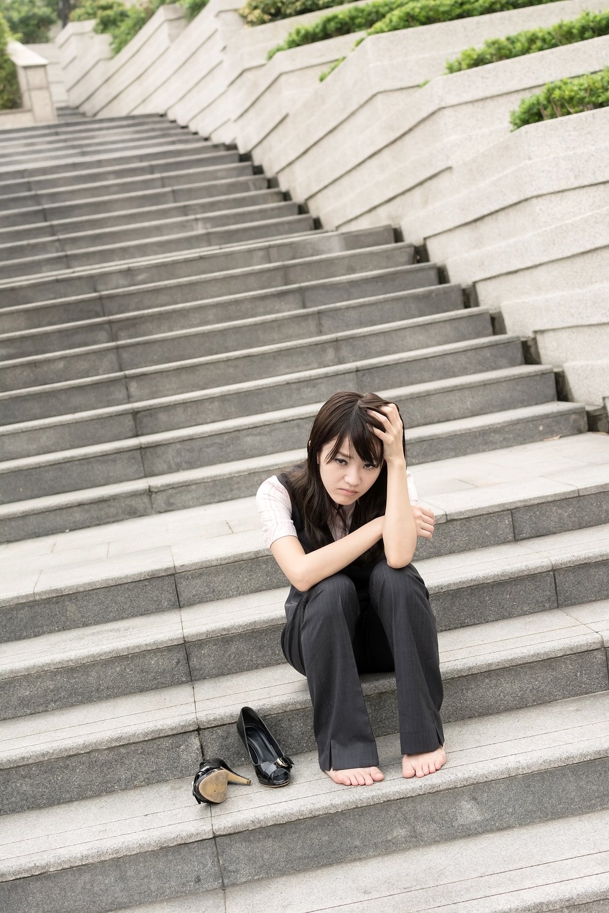 Worried Businesswoman Sitting on Stairs