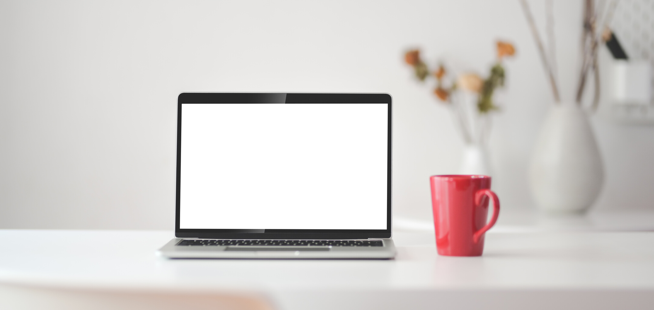 Black and Silver Laptop Computer Beside Red Cup