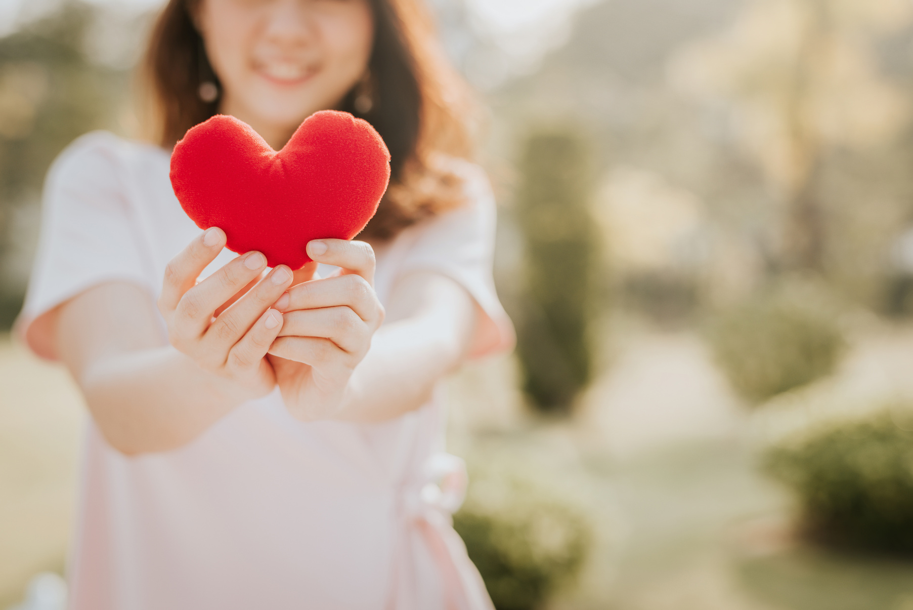 Woman Holding Heart Outdoors